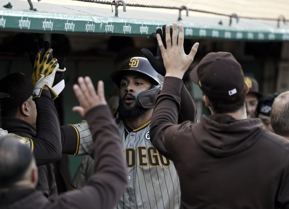 San Diego Padres' Fernando Tatis Jr., center, celebrates with teammates in the dugout after hitting a solo home run against the Oakland Athletics during the first inning of a baseball game Friday, Sept. 15, 2023, in Oakland, Calif. (AP Photo/Godofredo A. Vásquez)