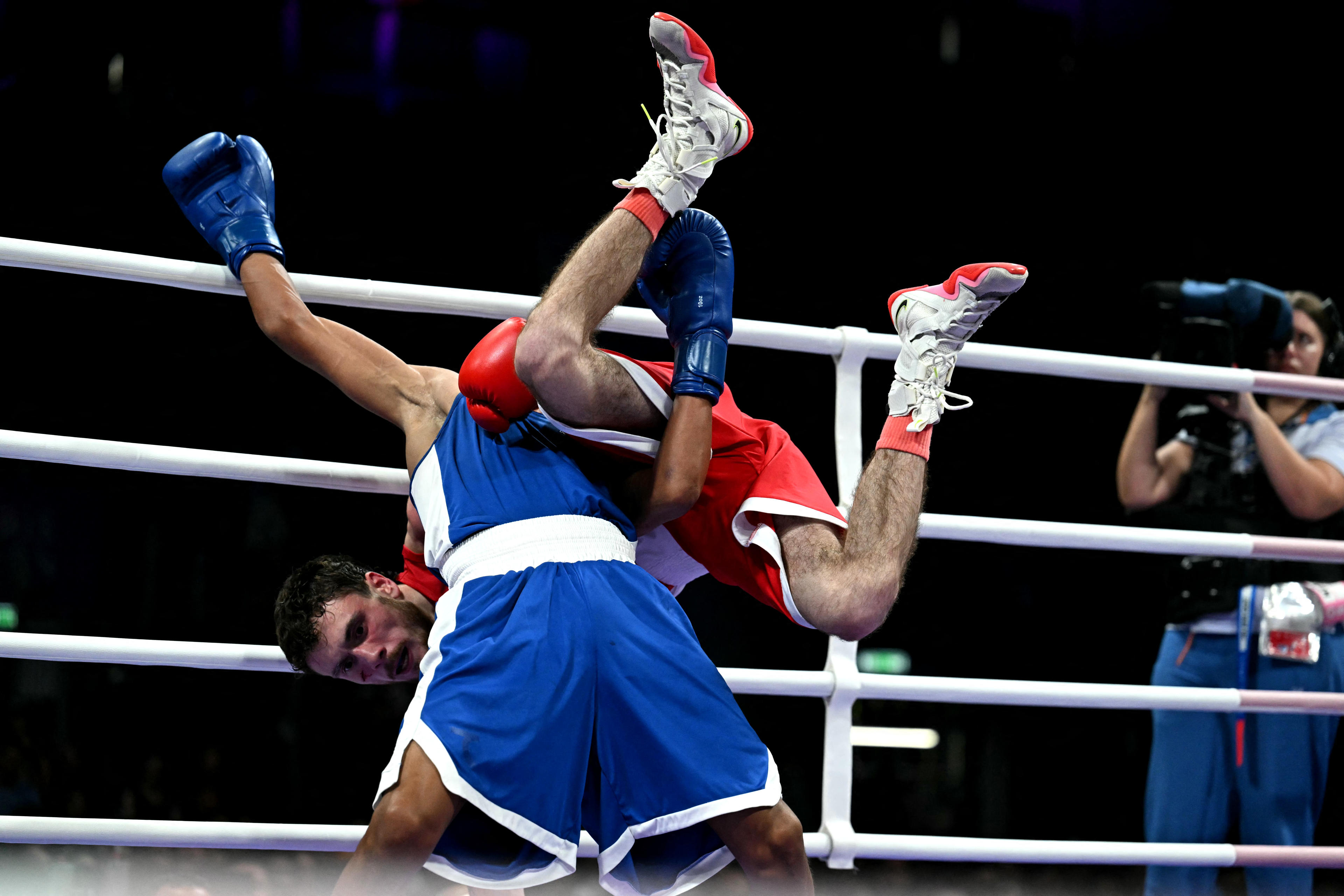 Dominican Republic's Yunior Alcantara Reyes (blue) fights against Azerbaijan's Nijat Huseynov in a men's 51kg preliminaries round of 16 boxing match ( Mohd Rasfan/AFP via Getty Images)