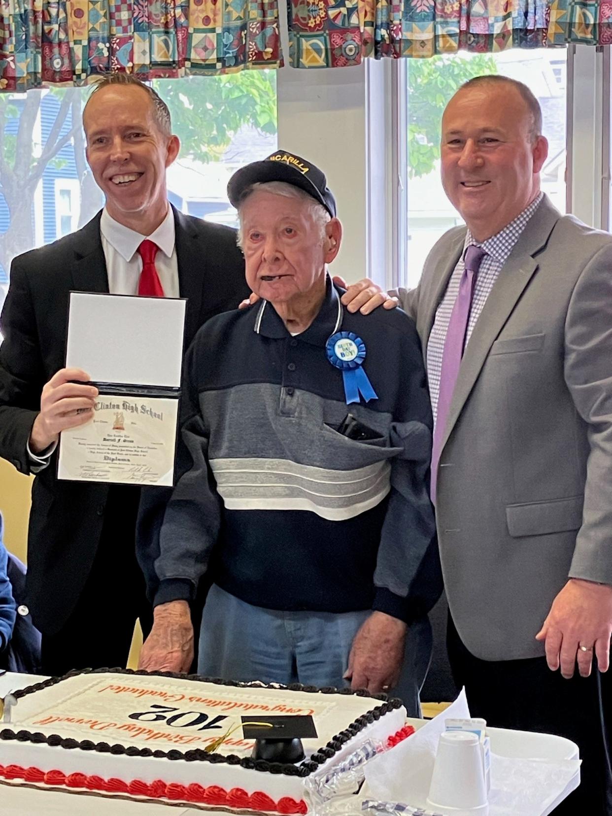 Patrick Adkins, Superintendent of Schools, presents Darrel Gress, center, with his Port Clinton High School Diploma on his 102nd Birthday Celebration along with PCHS Principal Gary Steyer.