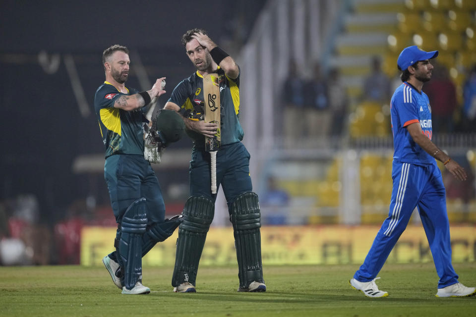 Australia's Glenn Maxwell, center, and captain Matthew Wade, left, leave the field after Australia won the third T20 cricket match against India in Guwahati, India, Tuesday, Nov. 28, 2023. (AP Photo/Anupam Nath)