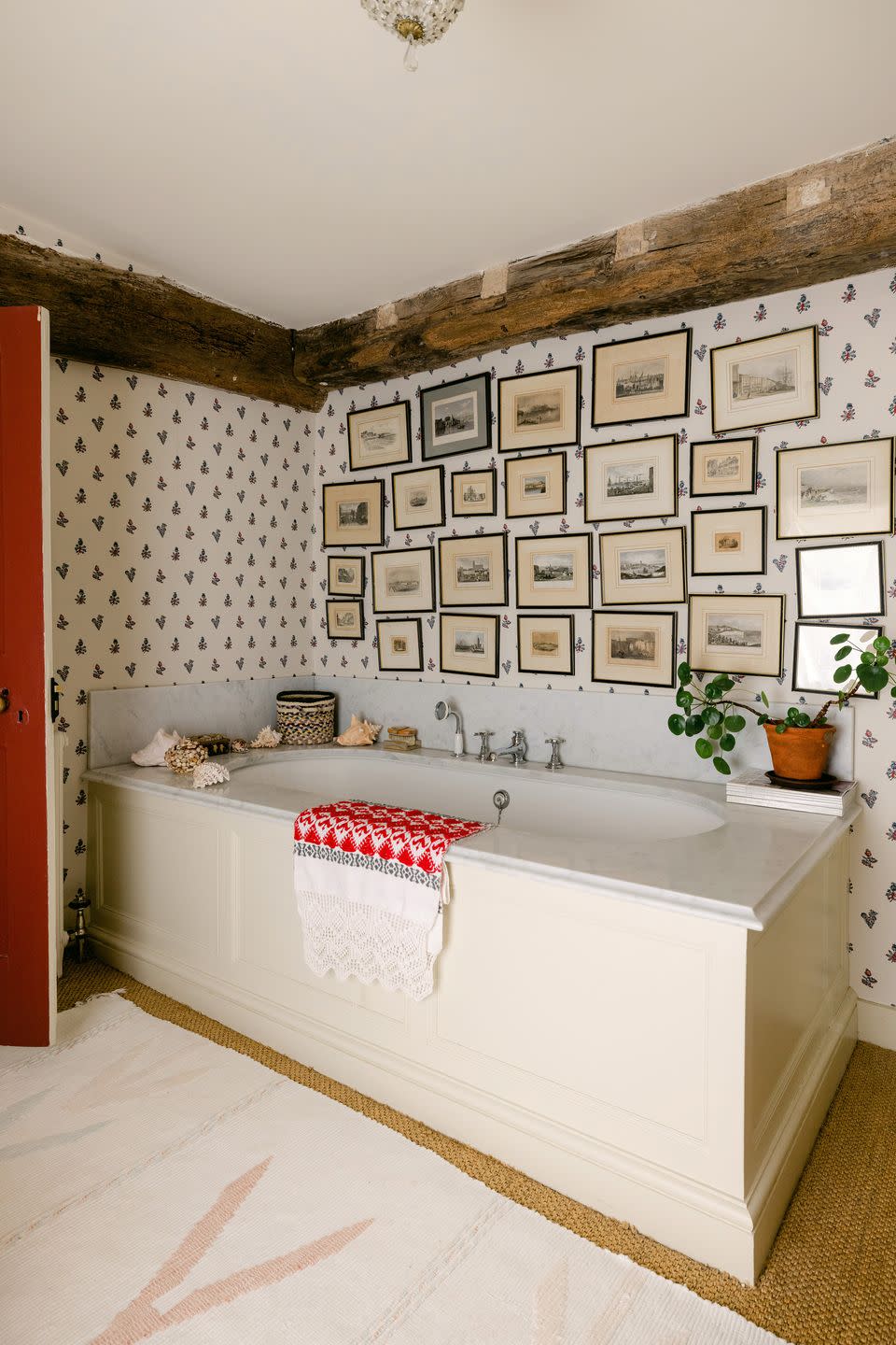 a bathroom with a bathtub and pictures on the wall