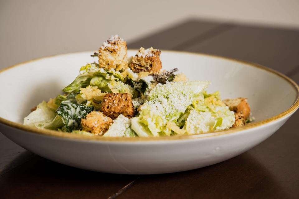Napa River Grill's classic Caesar Salad with romaine lettuce and Tuscan kale with parmesan crisps and garlic croutons.