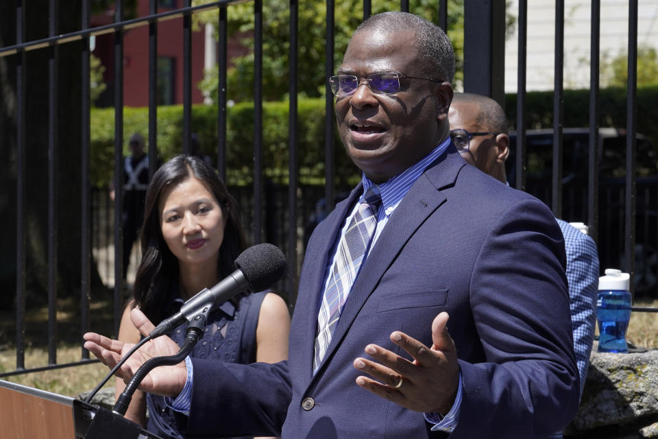 Michael Cox, right, who has been named as the next Boston police commissioner, faces reporters as Boston Mayor Michelle Wu, left, looks on during a news conference, Wednesday, July 13, 2022, in Boston's Roxbury neighborhood. Cox, who was beaten more than 25 years ago by colleagues who mistook him for a suspect in a fatal shooting, served in multiple roles with the Boston Police Department before becoming the police chief in Ann Arbor, Michigan, in 2019. (AP Photo/Steven Senne)