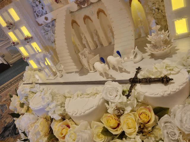 <p>David Woodruff for Bespoke Cakes by Sam</p> A closer look at the base of the castle featuring a coach and horses and a life-size sword
