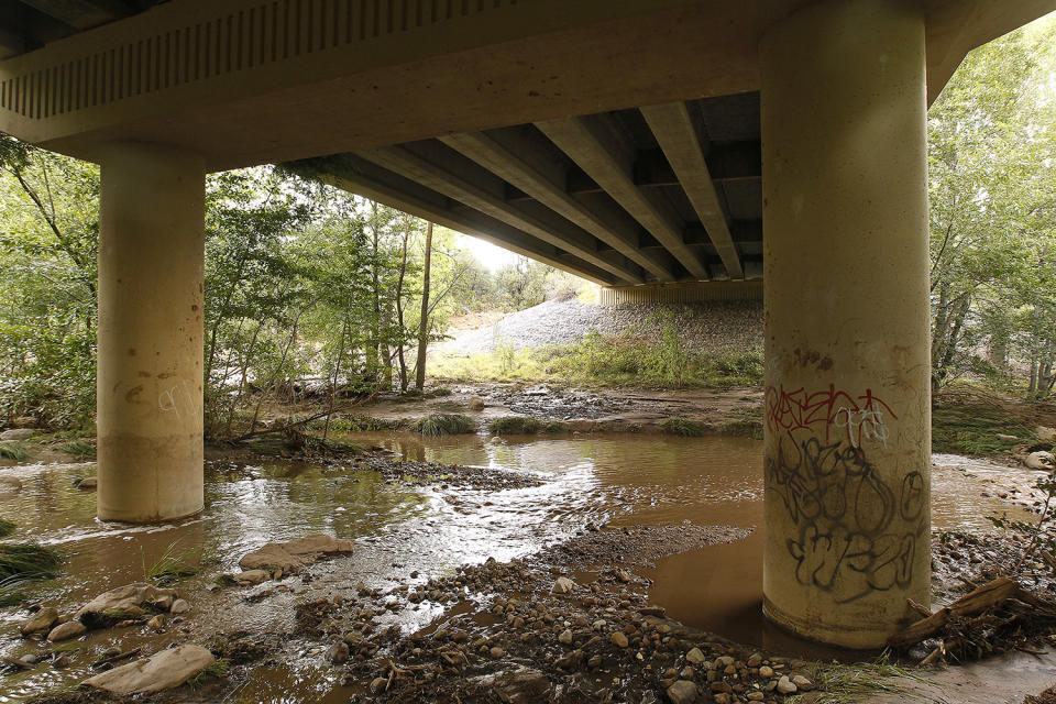 <p>Muddy floodwaters of the East Verde River flow under a bridge were at least one victim of a flash flood was found during a search and rescue operation by the Gila County Sheriff’s Office on Sunday, July 16, 2017, in Payson, Ariz. (AP Photo/Ralph Freso) </p>