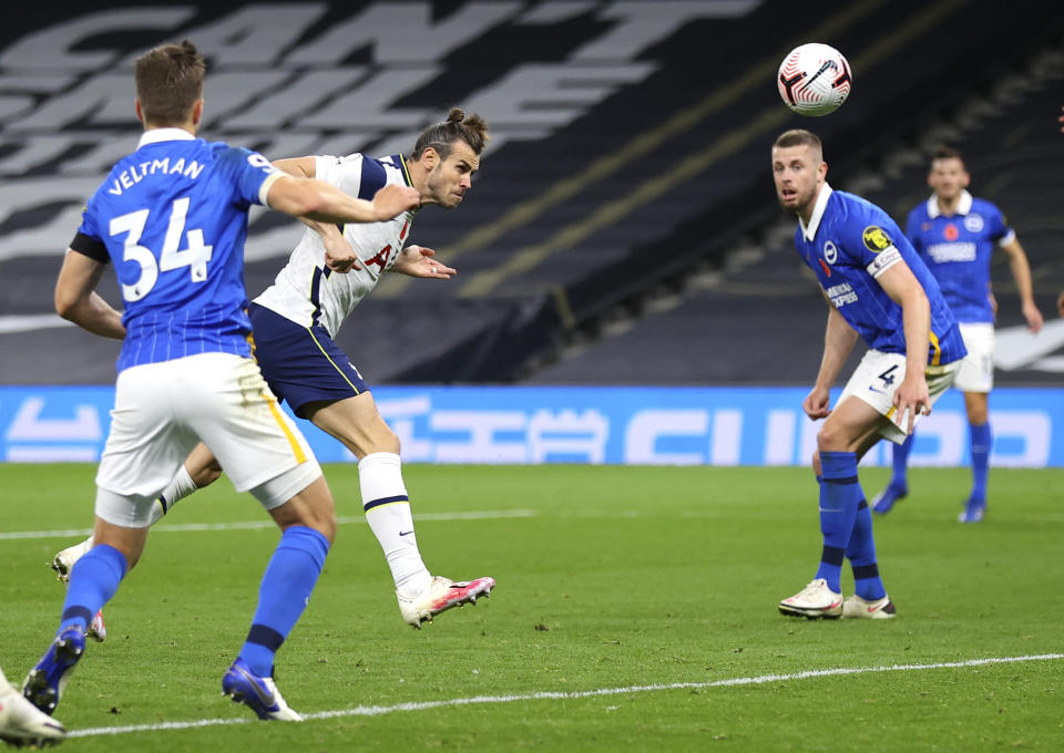 Tottenham's Gareth Bale, centre, heads the ball to score his team's second goal during the English Premier League soccer match between Tottenham Hotspur and Brighton & Hove Albion at Tottenham Hotspur Stadium, London, Sunday, Nov. 1, 2020. (Julian Finney/Pool via AP)