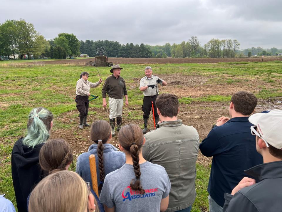 Michael Johnson, manager of the Green River National Wildlife Refuge in eastern Henderson County, explains techniques for planting tree saplings to a group of 24 Henderson County High ag students last Friday.