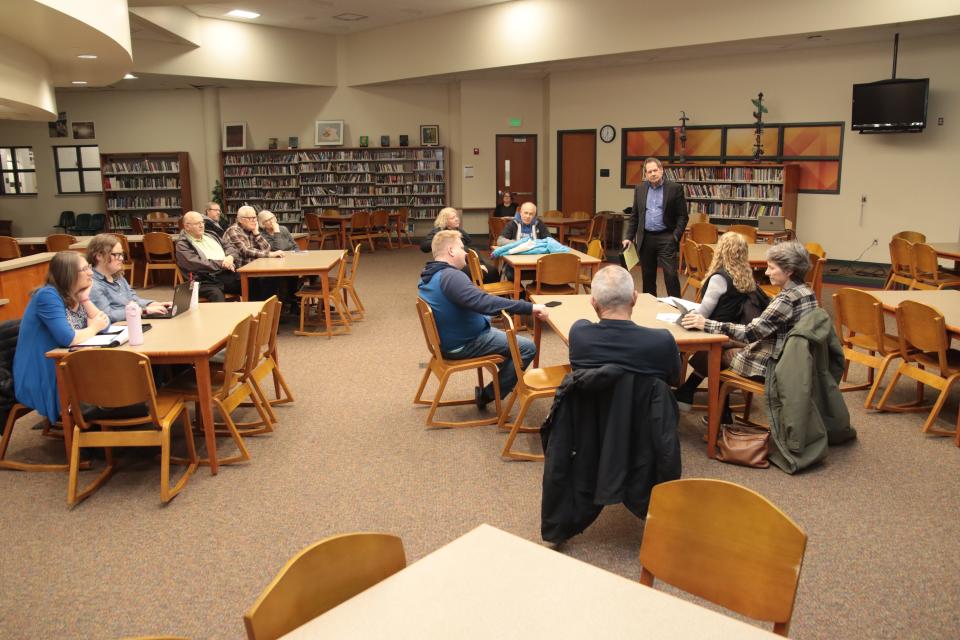 Rodney Green of the Michigan Association of School Boards, standing, listens to a comment during a community input-gathering session Monday at Tecumseh High School on what qualities residents would like to see in the next Tecumseh schools superintendent. Green is the Tecumseh school board's search consultant.