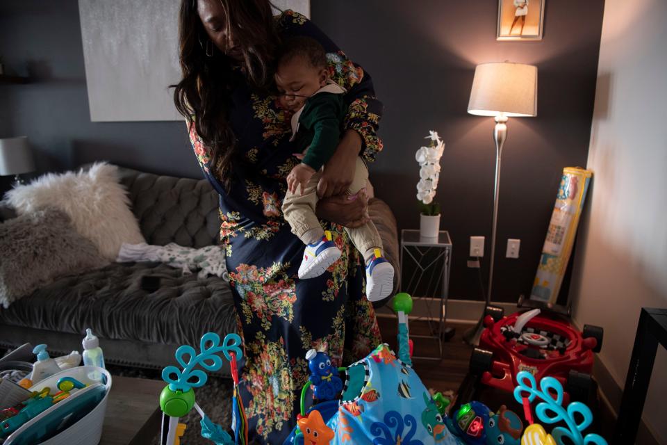 Sen. London Lamar D- Memphis, lifts her 7-month-old son Nylinn, from his bouncy chair in her apartment in Nashville, Tenn., Wednesday, March 13, 2024.