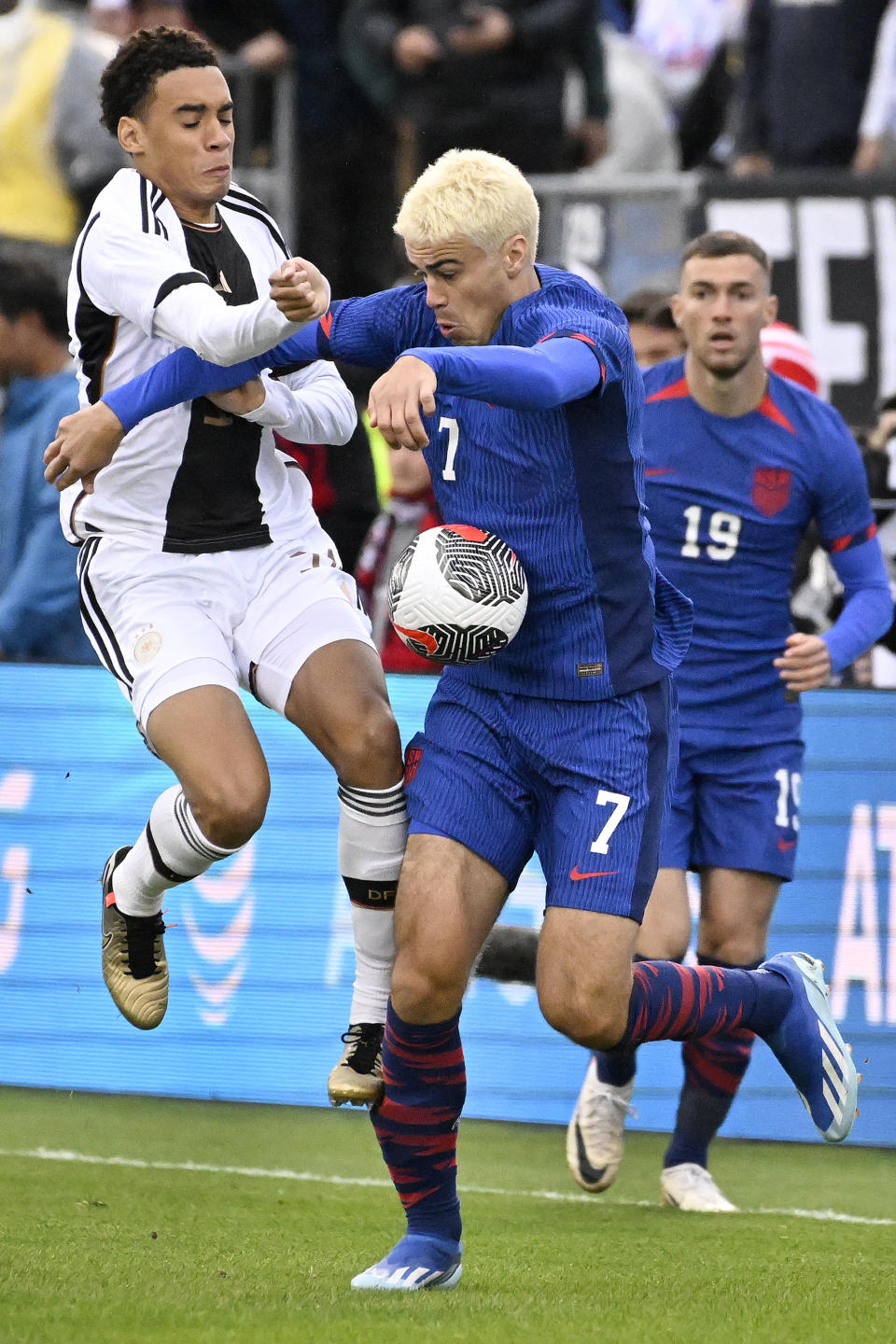 United States' Gio Reyna, right, takes control of the ball under pressure from Germany's Jamal Musiala during an international friendly soccer match at Pratt & Whitney Stadium at Rentschler Field, Saturday, Oct. 14, 2023, in East Hartford, Conn. (AP Photo/Jessica Hill)