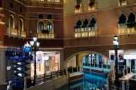 An employee checks a lamp post, at the Venetian Macao casino and hotel, following the coronavirus outbreak in Macau