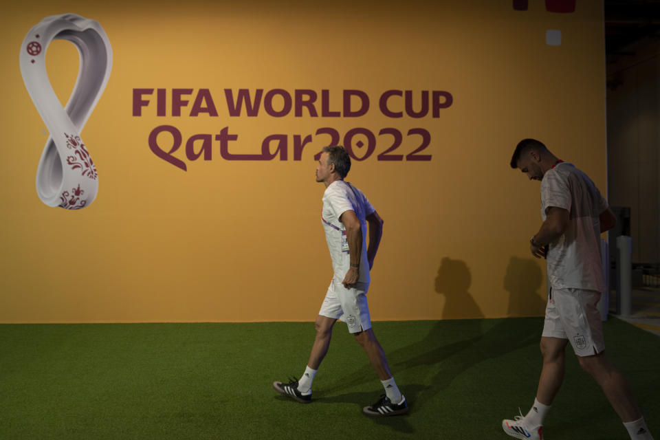 Spain's head coach Luis Enrique, left, and goalkeeper Unai Simon arrive ahead of an official news conference at Qatar University, in Doha, Qatar, Wednesday, Nov. 30, 2022. Spain will play its first final match in Group E in the World Cup against Japan on Dec. 1. (AP Photo/Julio Cortez)