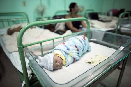 A new born baby rests beside his mother Dailyn Fleite (L), 29, at the Ana Betancourt de Mora Hospital in Camaguey, Cuba, June 19, 2015. REUTERS/Alexandre Meneghini