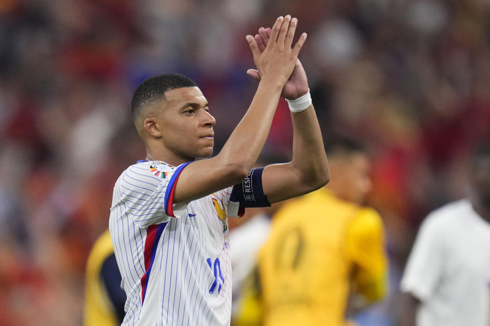 Kylian Mbappe of France applauds fans at the end of a semifinal match between Spain and France at the Euro 2024 soccer tournament in Munich, Germany, Tuesday, July 9, 2024. (AP Photo/Manu Fernandez)