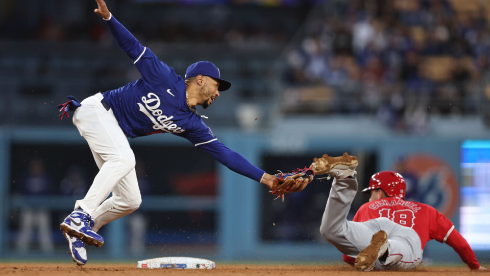 Mookie Betts of the Los Angeles Dodgers tries to tag a Los Angeles Angels player out on the foot
