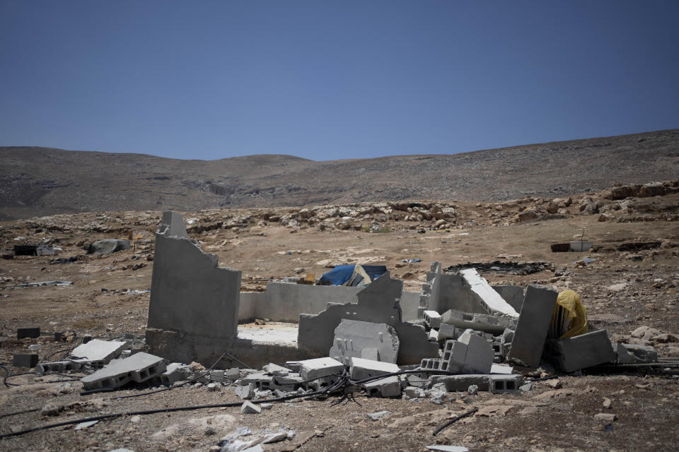 The ruins of a home, demolished by its Palestinian residents as they fled Ein Samiya village in the West Bank, Thursday, Aug. 10, 2023. This Bedouin community dismantled their homes and left in May, citing Israeli settler violence as their reason for leaving.(AP Photo/Maya Alleruzzo)