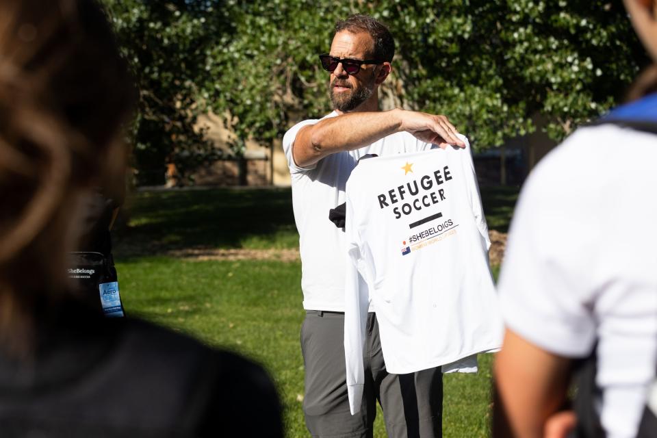 Adam Miles shows the #SheBelongs team members their new gear for traveling to the Women’s World Cup hosted by Australia and New Zealand at Lone Peak Park in Sandy on Thursday, July 6, 2023. #SheBelongs is a four-month program bringing together refugee and nonrefugee girls through soccer. | Megan Nielsen, Deseret News