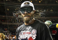 Washington Nationals outfielder Jayson Werth shakes beer and champagne out of his hair and beard while celebrating with teammates after the team clinched the National League East Division championship following their MLB baseball game against the Philadelphia Phillies in Washington, October 1, 2012. REUTERS/Jonathan Ernst (UNITED STATES - Tags: SPORT BASEBALL TPX IMAGES OF THE DAY)