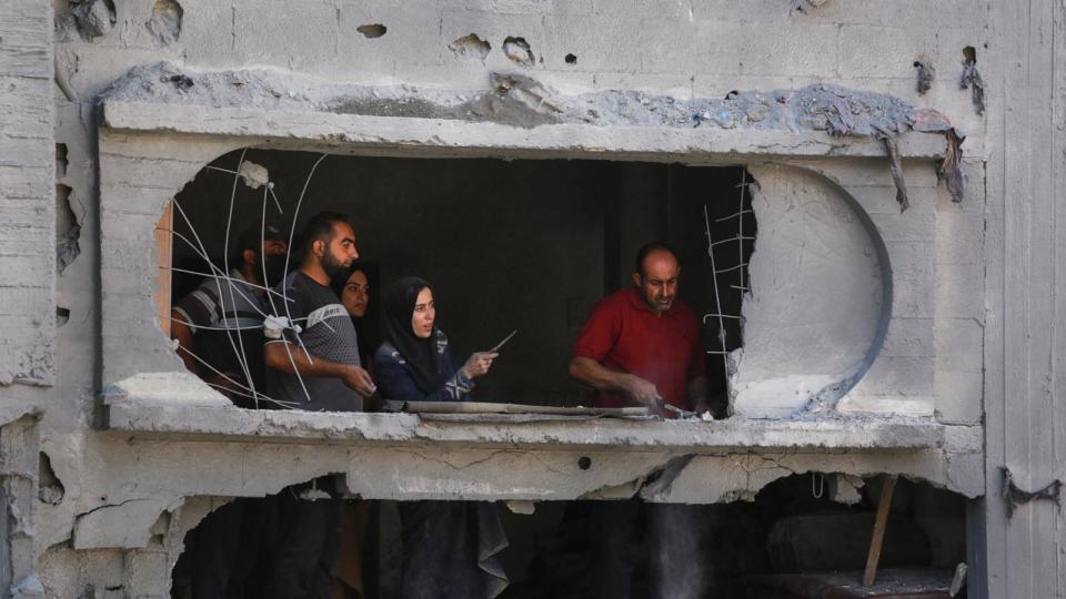 PHOTO: Palestinians clear the rubble from a damaged apartment block following overnight Israeli strikes in al-Bureij refugee camp in the central Gaza Strip, June 18, 2024. (Bashar Taleb/AFP via Getty Images)