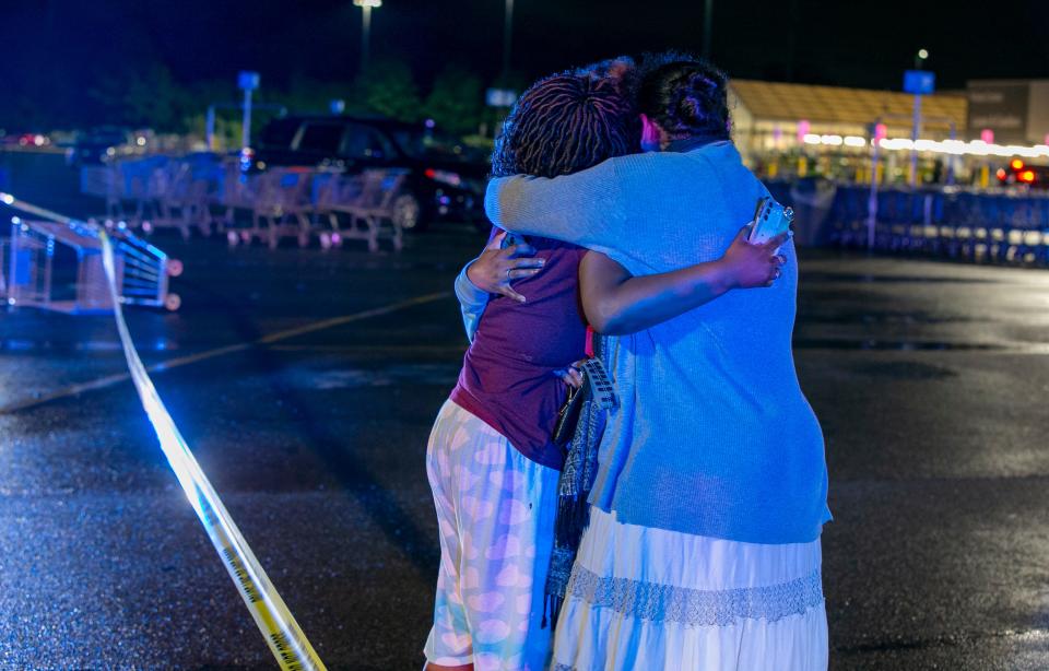 People embrace after one person was killed, and another was hospitalized after a shooting at the Walmart in Fairfield Township Thursday, May 26, 2022. Investigators said the suspect was attempting to steal items from the store. As the suspect attempted to shoplift, some employees and bystanders tried to stop him and block his exit.Â Police said two of the individuals who tried to stop were shot.Â Police said the suspect is still at large.