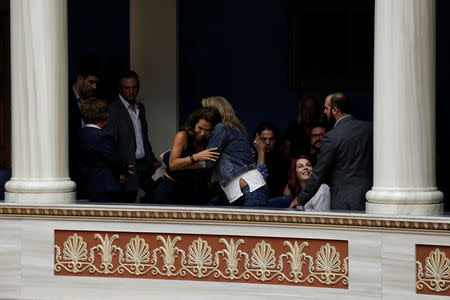 People celebrate following a parliamentary vote of a law that allows citizens to declare a gender change on official documents in Athens, Greece October 10, 2017. REUTERS/Costas Baltas