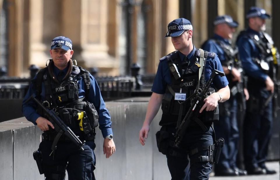 Armed police outside the Houses of Parliament in Westminster following the incident (EPA)