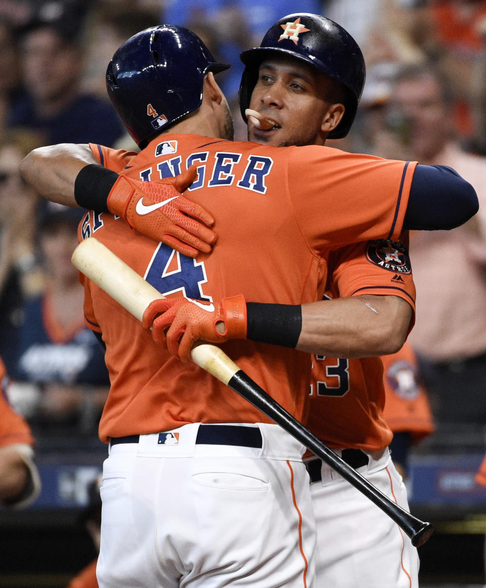 Houston Astros' George Springer, left, hugs Michael Brantley after hitting a solo home run off Los Angeles Angels starting pitcher Jose Rodriguez during the first inning of a baseball game, Sunday, Sept. 22, 2019, in Houston. (AP Photo/Eric Christian Smith)