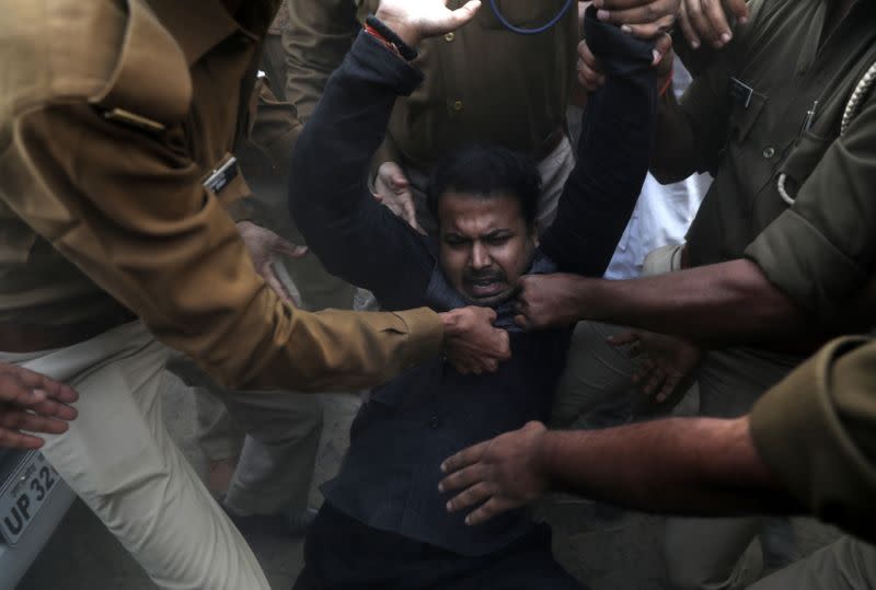 A supporter of India's main opposition Congress party is detained by police during a protest against Uttar Pradesh state government after a lawmaker from ruling BJP visited the family of a 23-year-old rape victim in Unnao