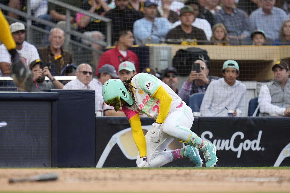 San Diego Padres' Fernando Tatis Jr. takes a moment after being hit by a pitch during the third inning of a baseball game against the Milwaukee Brewers, Friday, June 21, 2024, in San Diego. (AP Photo/Gregory Bull)