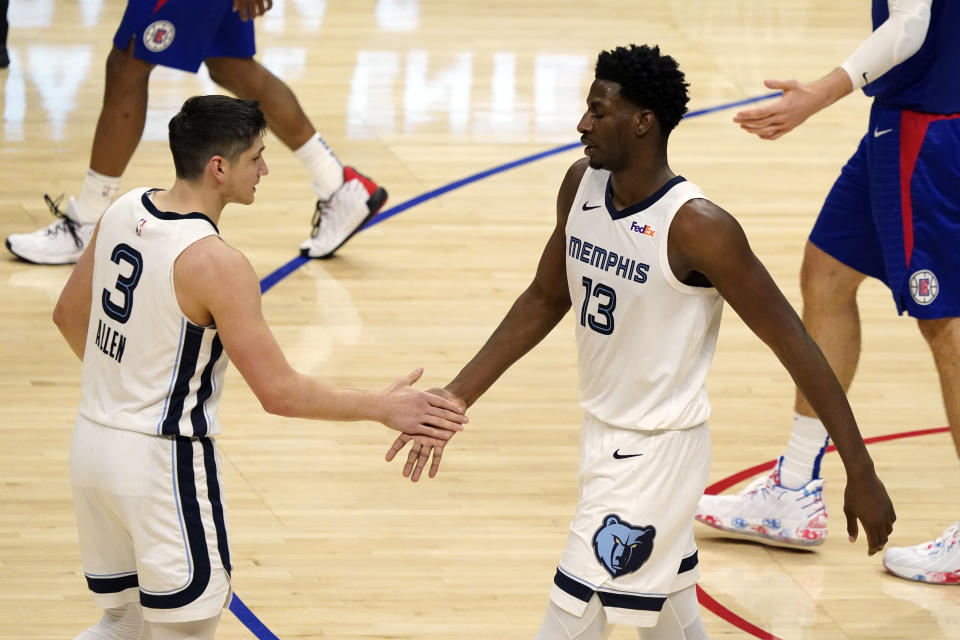 Memphis Grizzlies forward Jaren Jackson Jr. (13) shakes hands with guard Grayson Allen (3) during the second half of the team's NBA basketball game against the Los Angeles Clippers on Wednesday, April 21, 2021, in Los Angeles. (AP Photo/Marcio Jose Sanchez)