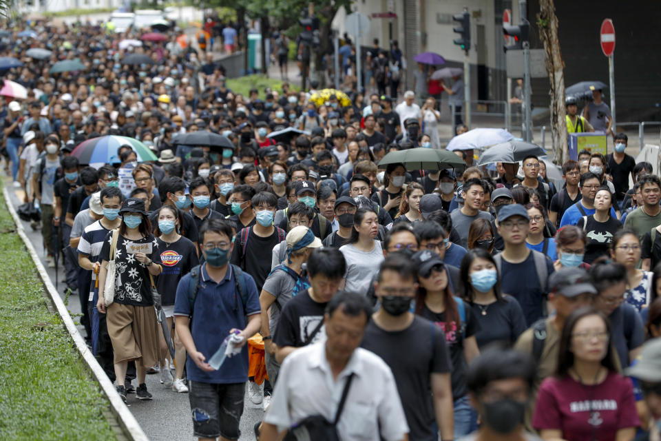 Pro-democracy protesters march in a Hong Kong street Saturday, Aug. 17, 2019. Another weekend of protests is underway in Hong Kong as Mainland Chinese police are holding drills in nearby Shenzhen, prompting speculation they could be sent in to suppress the protests. (AP Photo/Vincent Thian)