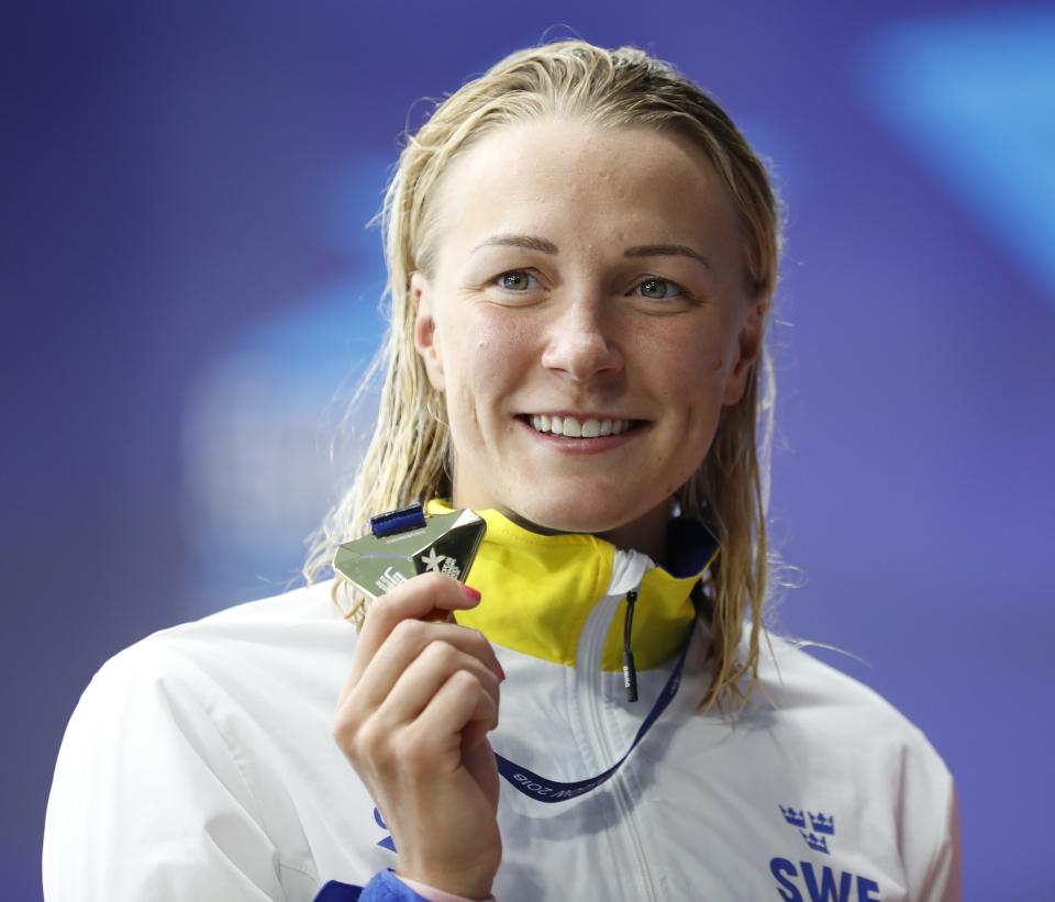 Sarah Sjoestroem of Sweden poses with her gold medal on the podium of the 100 meters freestyle women final at the European Swimming Championships in Glasgow, Scotland, Wednesday, Aug. 8, 2018. (AP Photo/Darko Bandic)