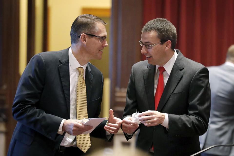 Sen. Randy Feenstra, R-Hull, talks with Sen. Roby Smith, R-Davenport, right, during the opening day of the Iowa Legislature, Monday, Jan. 14, 2019, at the Statehouse in Des Moines, Iowa. (AP Photo/Charlie Neibergall)