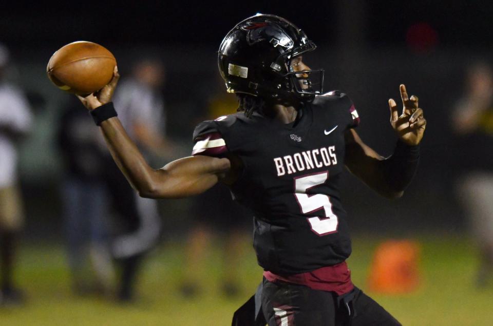 Ahmad Haston (5) of Palm Beach Central drops back to pass against Treasure Coast in the third quarter of the Class 8A Region Championship. Friday, Nov. 26, 2021.