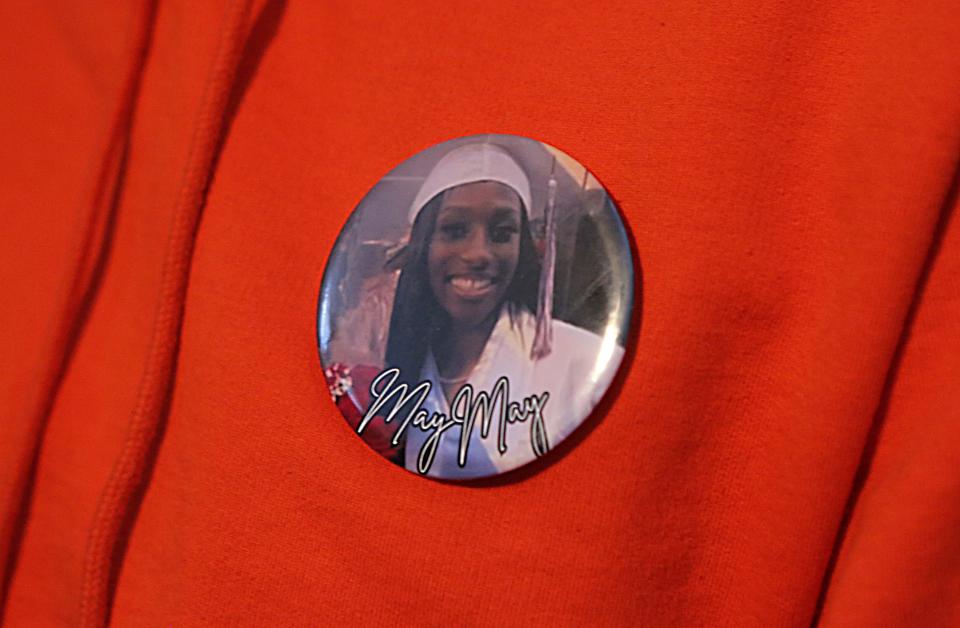 Charlotte De Silva Davis wears a pin with her a picture of her niece Camay De Silva's graduation picture on it. Camay was fatally shot while visiting Delaware State University on April 21.