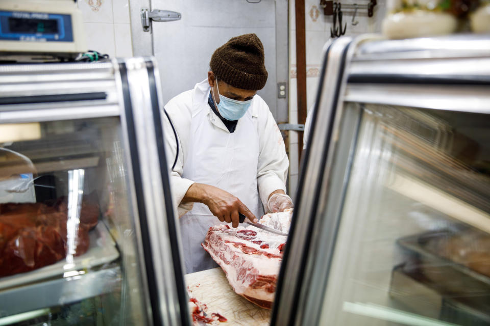 A butcher prepares a cut of meat in the halal grocery store Fertile Crescent in Brooklyn, N.Y., on May 5, 2021. (Julius Constantine Motal / NBC News)