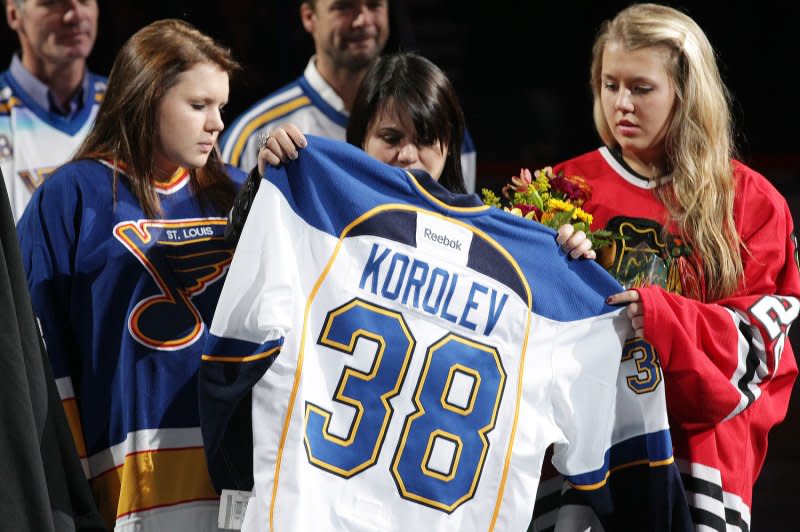 The family of former St. Louis Blues player Igor Korolev hold his jersey during a tribute ceremony before the St. Louis Blues-Chicago Blackhawks hockey game at the Scottrade Center in St. Louis on November 8, 2011. Korolev was among those killed on September 7, 2011, when the plane carrying their KHL team, Lokomotiv Yaroslavl, crashed in Russia. File Photo by Bill Greenblatt/UPI