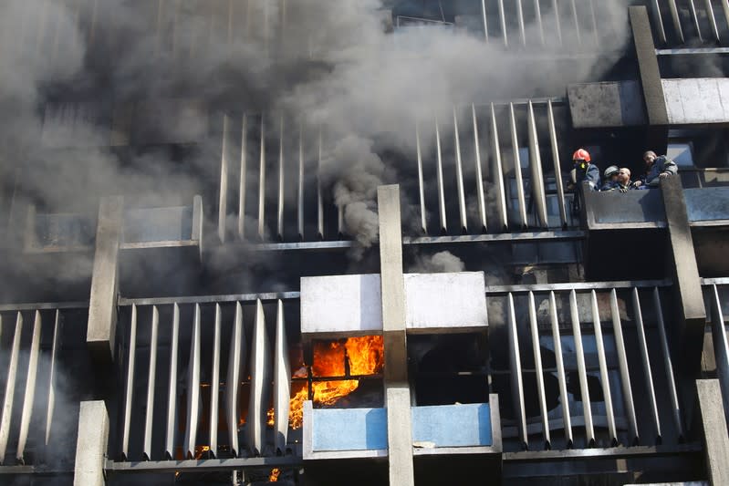 Firemen work to extinguish a fire in a building in Baghdad