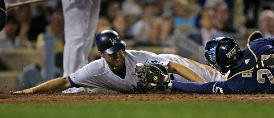 Dodgers baserunner Jeff Kent, left, grimaces as he gets tagged out at the plate by San Diego Padre catcher Josh Bard.