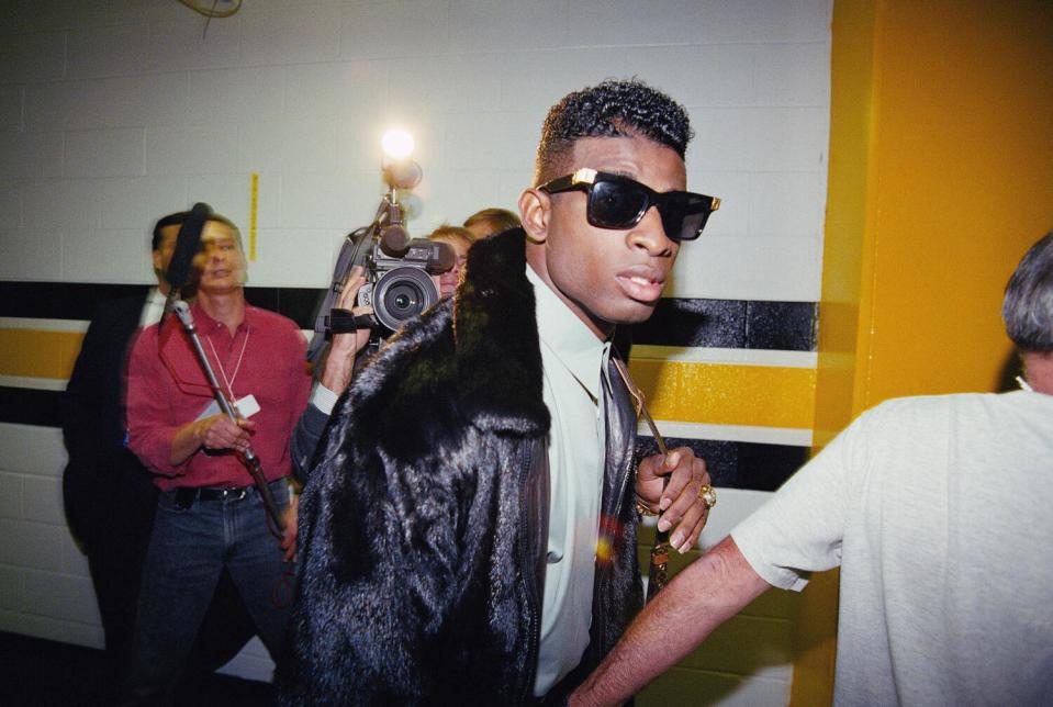 Deion Sanders, of the Atlanta Braves, leaves Three Rivers Stadium in Pittsburgh to rejoin the Atlanta Falcons