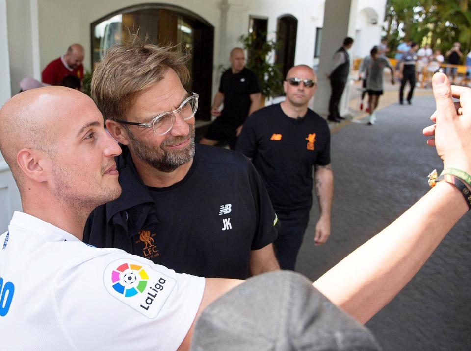 Jurgen Klopp poses with a football fan in Spain: Rex Features