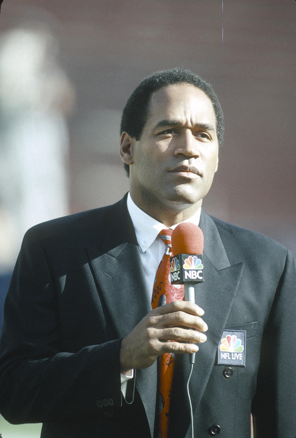 UNSPECIFIED – CIRCA 1991: NBC Football Analyst O.J. Simpson on the air before the start of an NFL football game circa 1991.