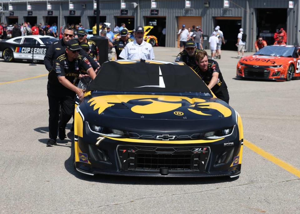 Jun 16, 2024; Newton, Iowa, USA; The team of NASCAR Cup Series driver Corey LaJoie (7) rolls his car to pit crew at Iowa Speedway.