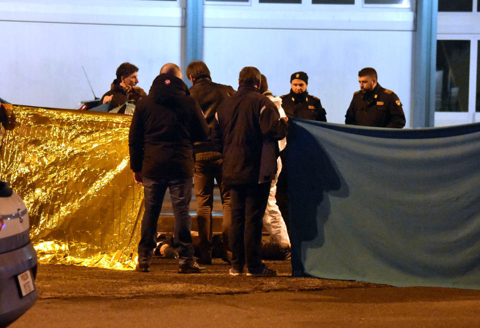 Italian police cordon off an area around a body after a shootout between police and a man in Milan's Sesto San Giovanni neighborhood, early Friday, Dec. 23, 2016. Italy's interior minister Marco Minniti says the man killed in an early-hours shootout in Milan is "without a shadow of doubt" the Berlin Christmas market attacker Anis Amri. (AP Photo/Daniele Bennati)