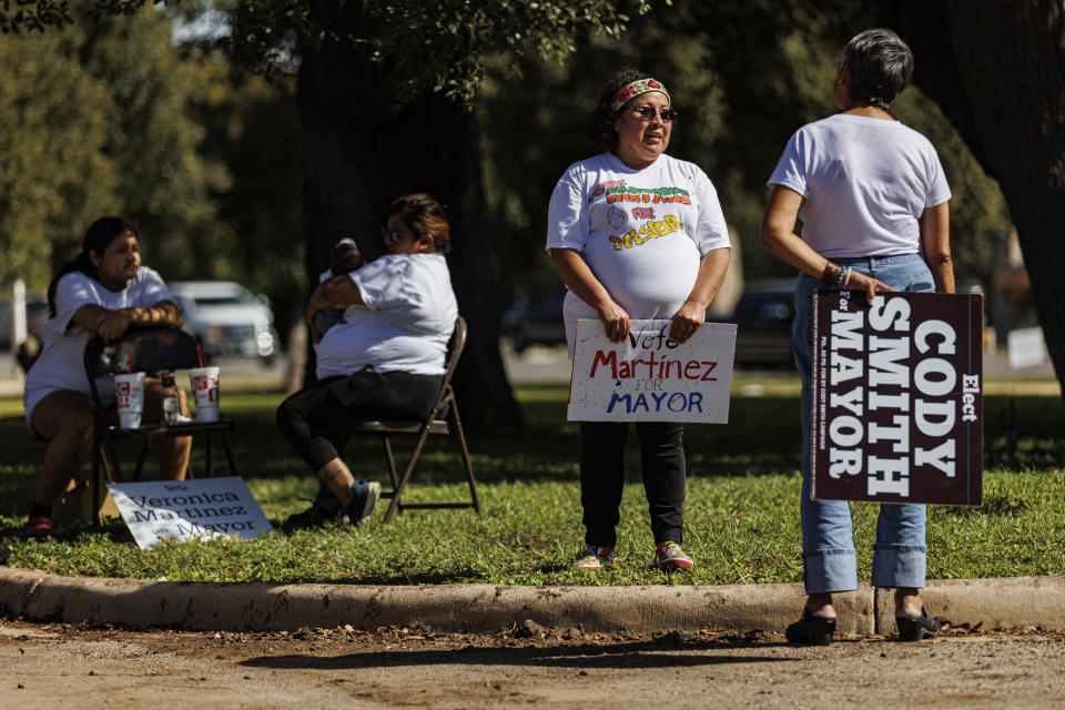 Uvalde mayoral candidate Veronica Martinez, center, talks with resident Diana Olvedo-Karau, who has been campaigning for candidate Cody Smith, outside of the SSGT Willie de Leon Civic Center on Election Day in Uvalde, Texas, Tuesday evening, Nov. 7, 2023. In Uvalde’s first mayoral race since the Robb Elementary School shooting, Smith won back the job Tuesday. (Sam Owens/The San Antonio Express-News via AP)