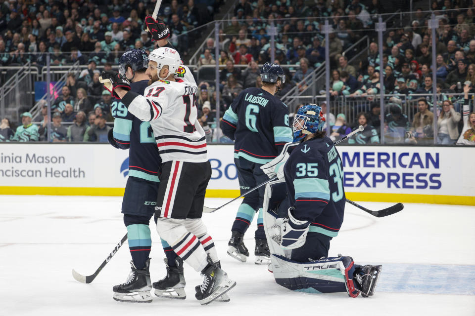 Chicago Blackhawks left wing Nick Foligno (17) reacts to a goal by right wing Joey Anderson (15) as Seattle Kraken goaltender Joey Daccord (35) looks on during the first period of an NHL hockey game Wednesday, Jan. 24, 2024, in Seattle. (AP Photo/Jason Redmond)