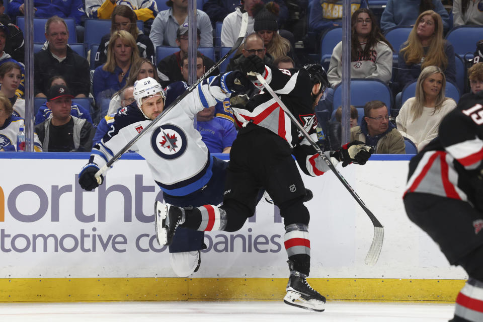 Winnipeg Jets right wing Nino Niederreiter (62) and Buffalo Sabres left wing Zemgus Girgensons collide during the second period of an NHL hockey game, Sunday, March 3, 2024, in Buffalo, N.Y. (AP Photo/Jeffrey T. Barnes)