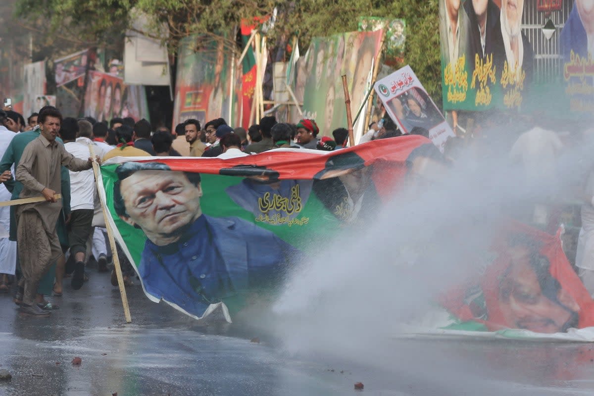 Police fire teargas to disperse the supporters of former Prime Minister Imran Khan as it tries to arrest Khan (EPA)