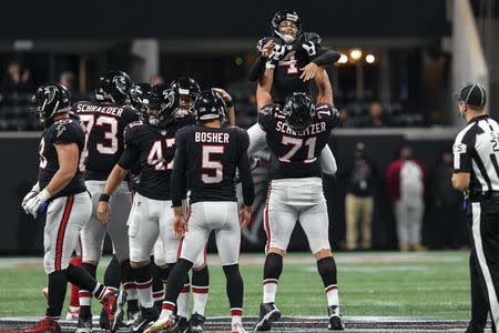 Oct 22, 2018; Atlanta, GA, USA; Atlanta Falcons kicker Giorgio Tavecchio (4) reacts with offensive guard Wes Schweitzer (71) after kicking a 56 yard field goal against the New York Giants during the fourth quarter at Mercedes-Benz Stadium. Mandatory Credit: Dale Zanine-USA TODAY Sports