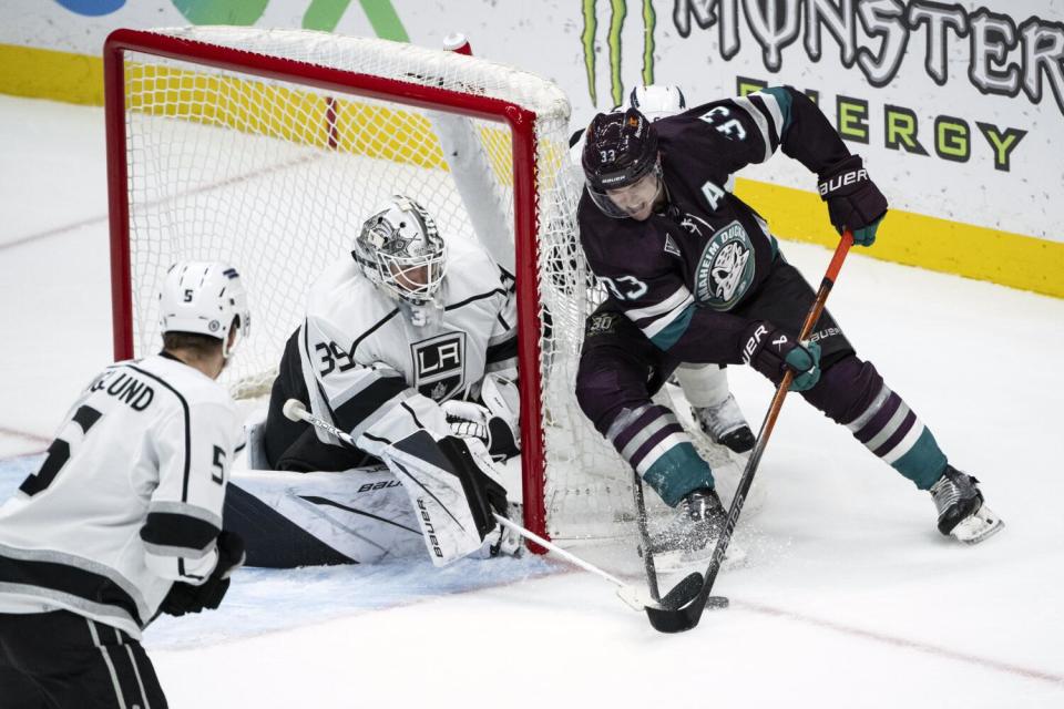 Kings goaltender Cam Talbot pokes the puck away from Ducks forward Jakob Silfverberg during a game on Nov. 24.